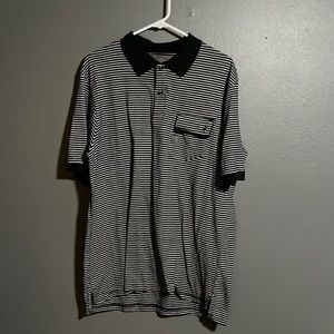 Navy blue and white Polo with pocket size XXL brand name is MCMXCIV